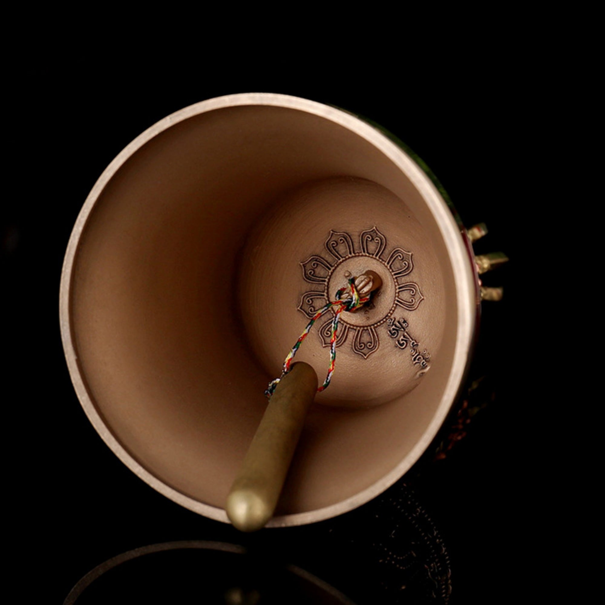 Ceramic cup with a decorative handle on a black background