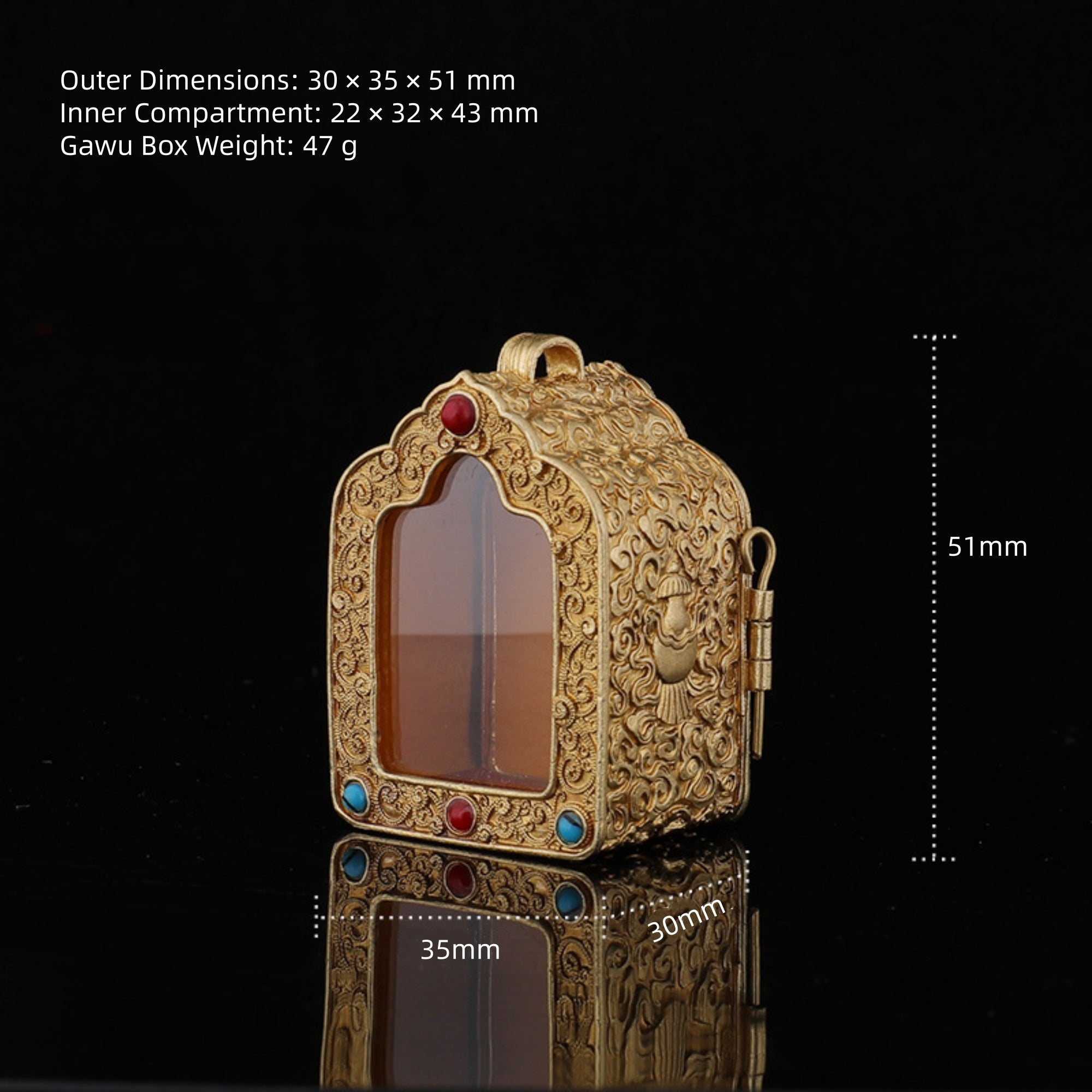 An ornate gold-toned carved box with a transparent front window and small colored gem accents, shown on a black background with overlaid dimensions and weight text.