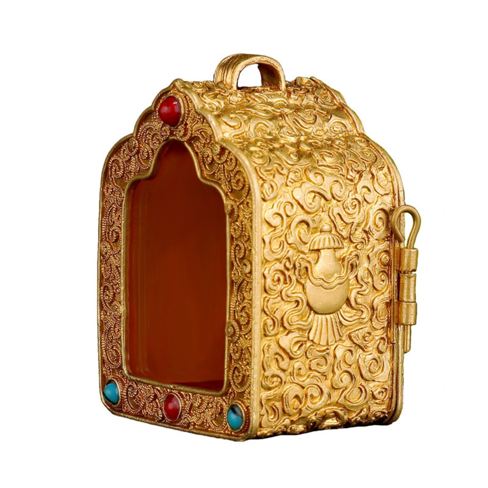 An ornate gold-toned decorative box with intricate embossed floral patterns, a hinged clasp, a top loop handle, and small red and turquoise gemstone accents, shown on a plain white background.