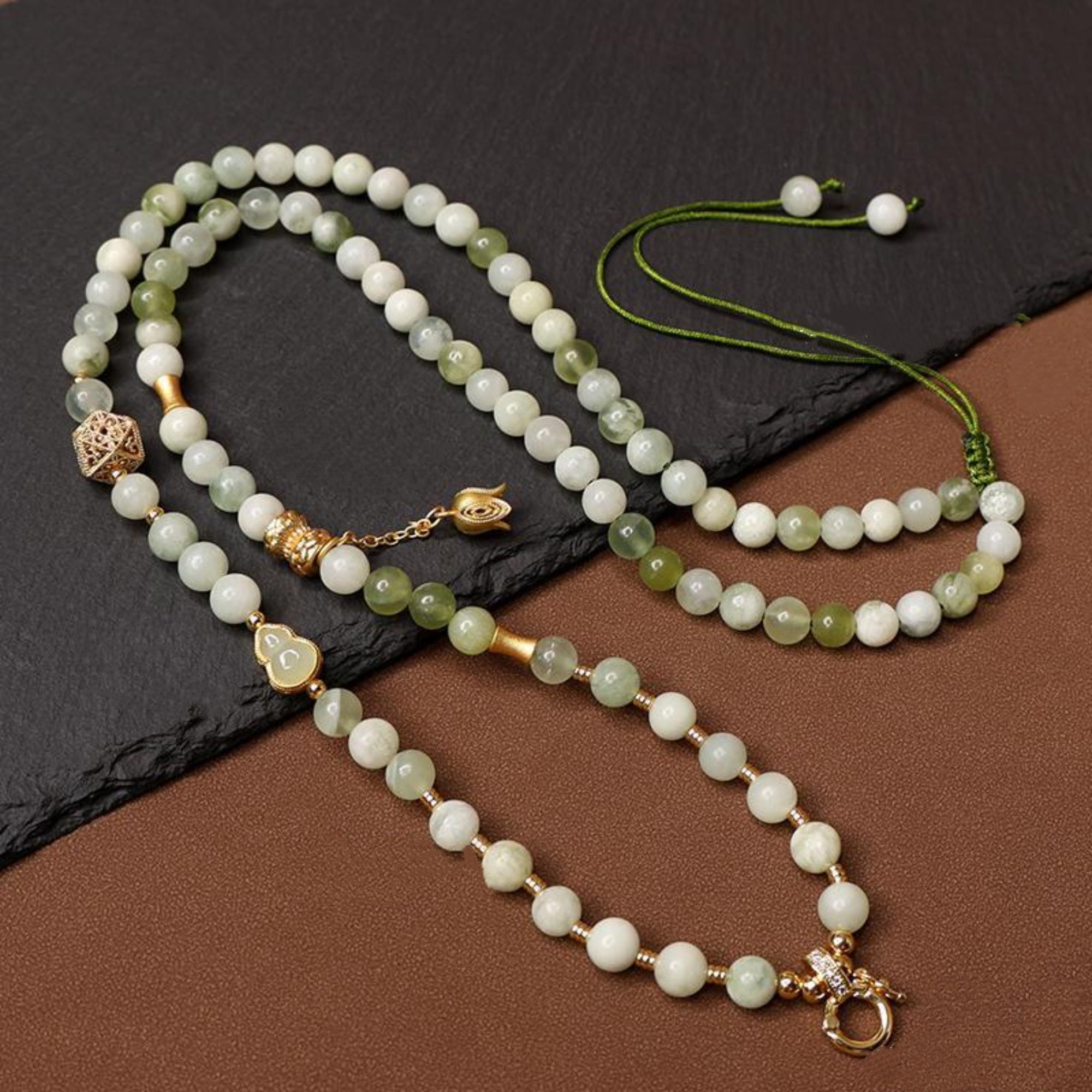 Beaded necklace with gold accents on a dark surface