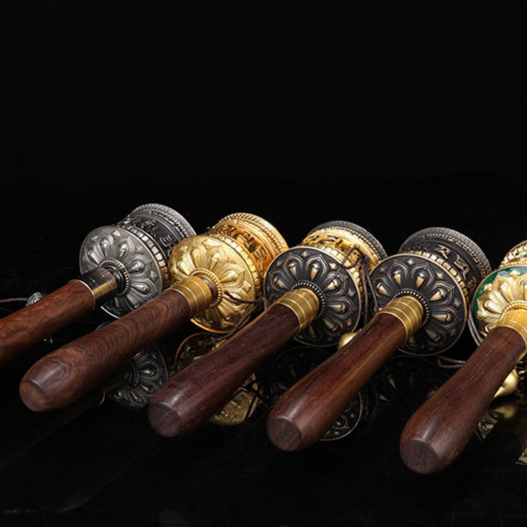 Set of decorative door handles with wooden handles and metallic fixtures on a black background