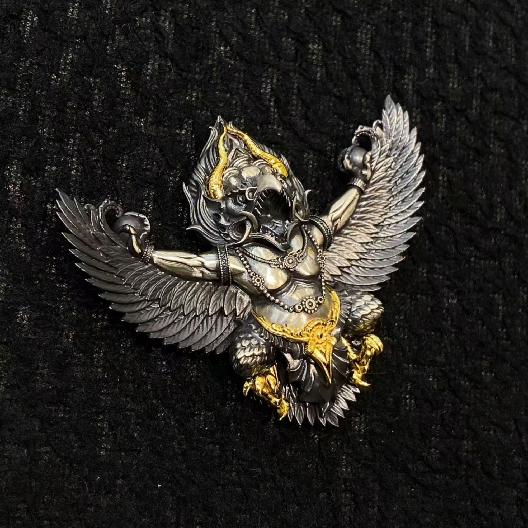 Decorative angel figurine with wings on a black background