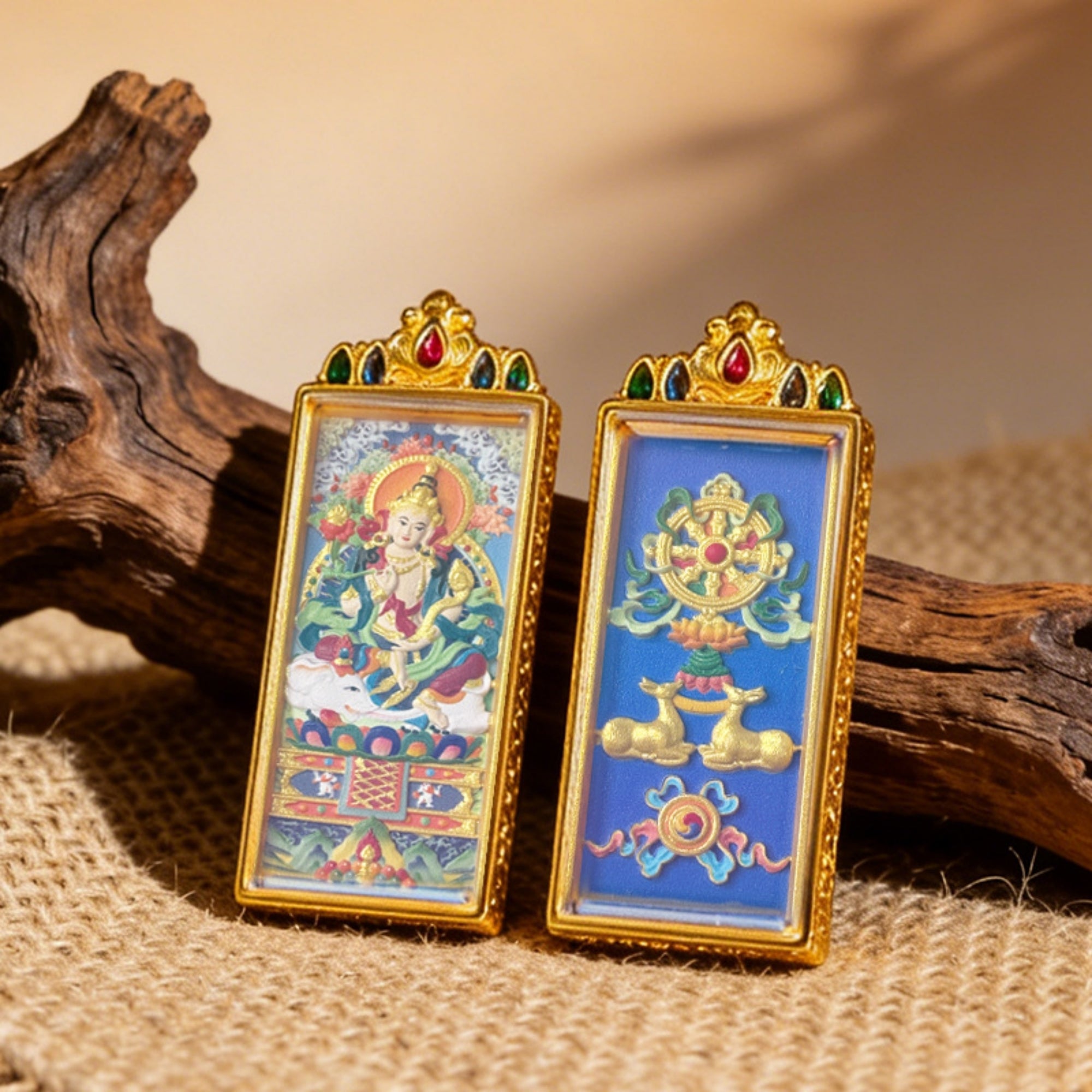 Two ornate framed artworks on a textured surface with wooden elements.
