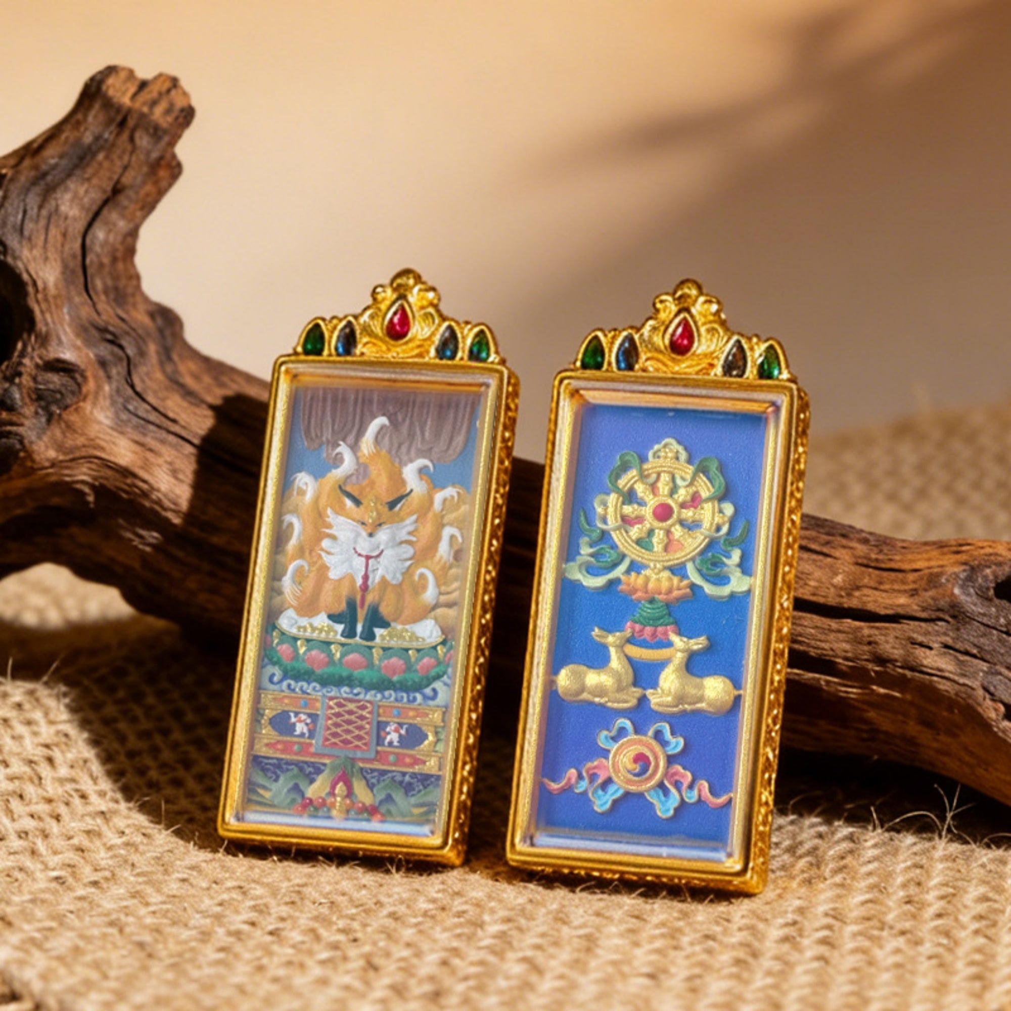 Two ornate framed artworks on a textured surface with wooden elements.