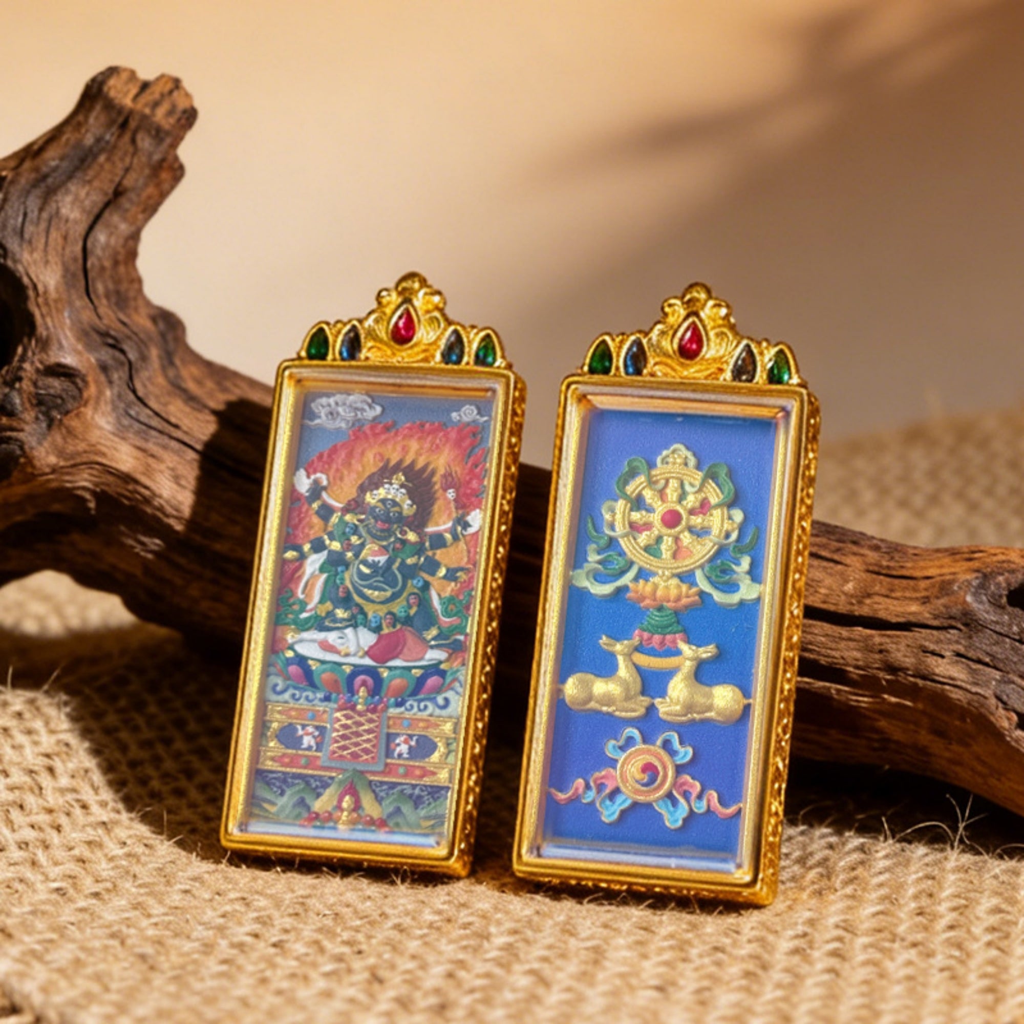 Two ornate framed artworks on a textured surface with wooden elements.