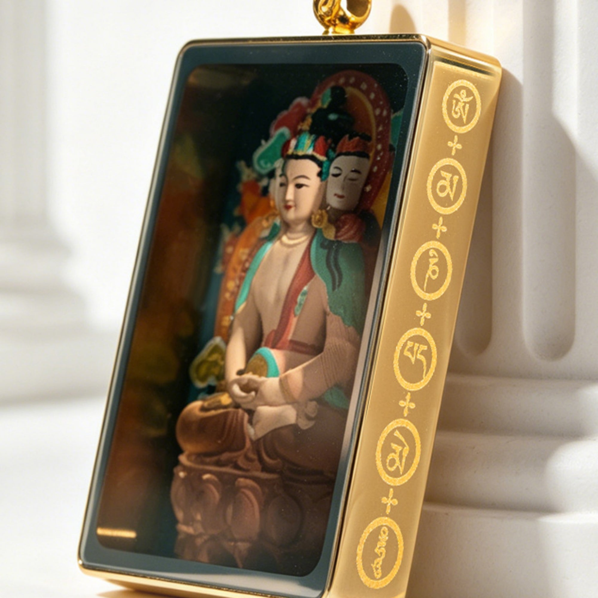 Decorative item with a figure of a seated deity and gold accents on a white background