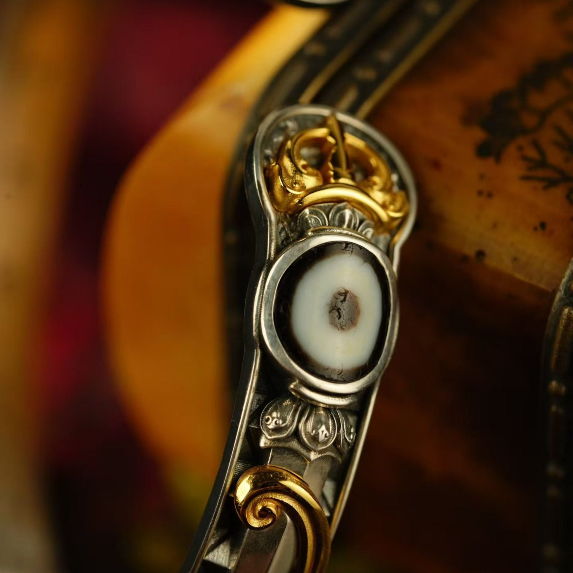 Close-up of a decorative object with gold and silver elements on a blurred background
