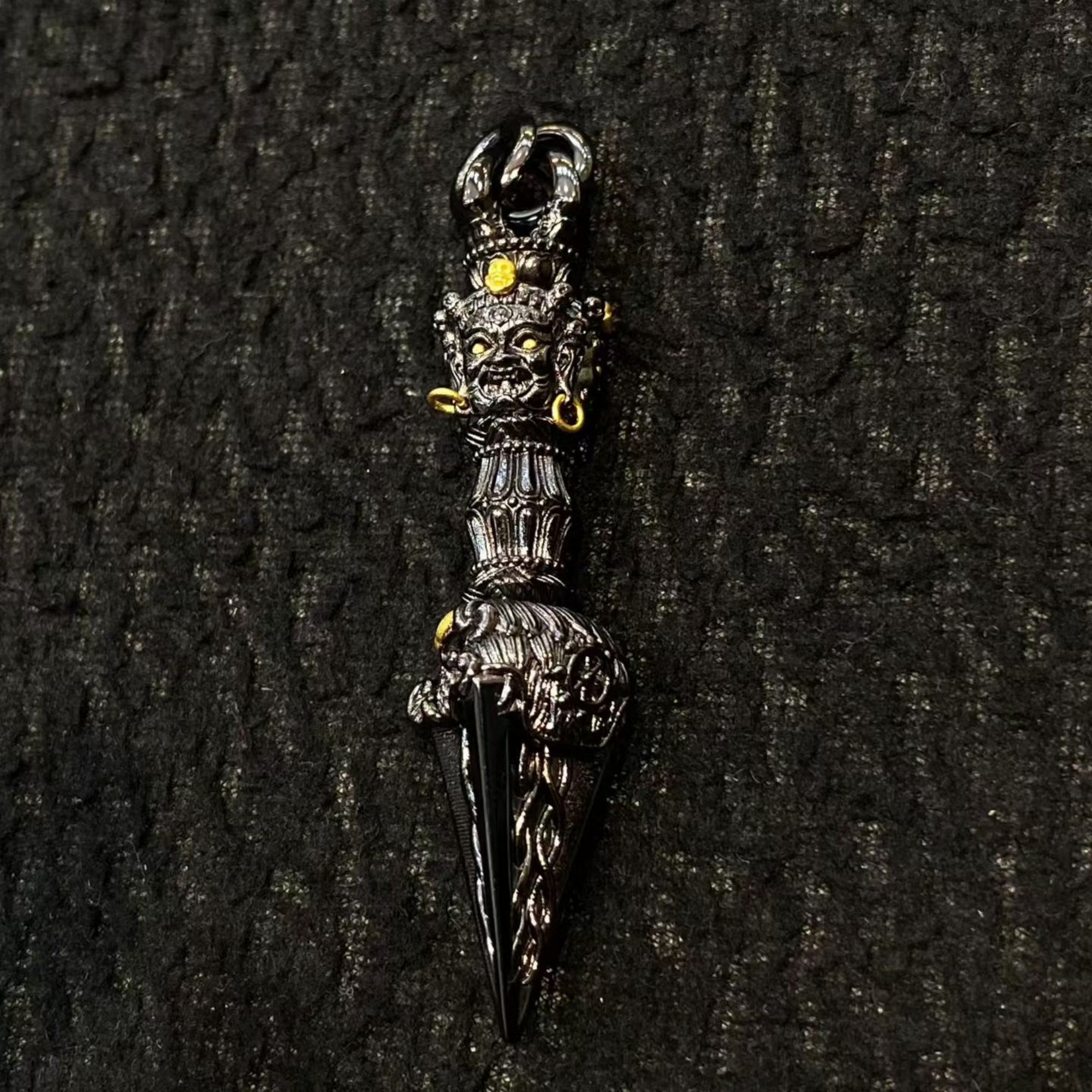 Decorative dagger with intricate designs on a dark textured background