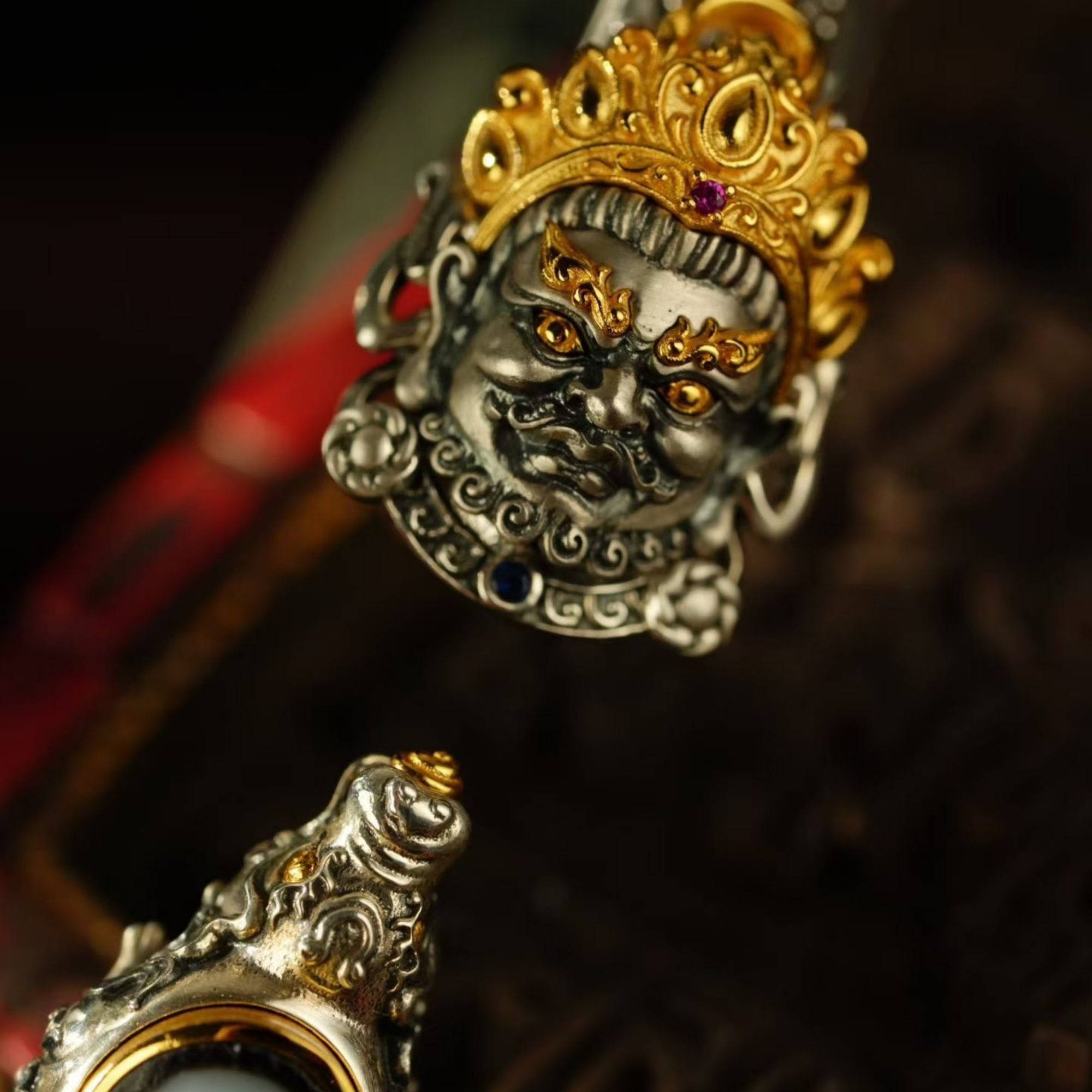 Decorative headpiece with intricate designs and gold accents on a dark background