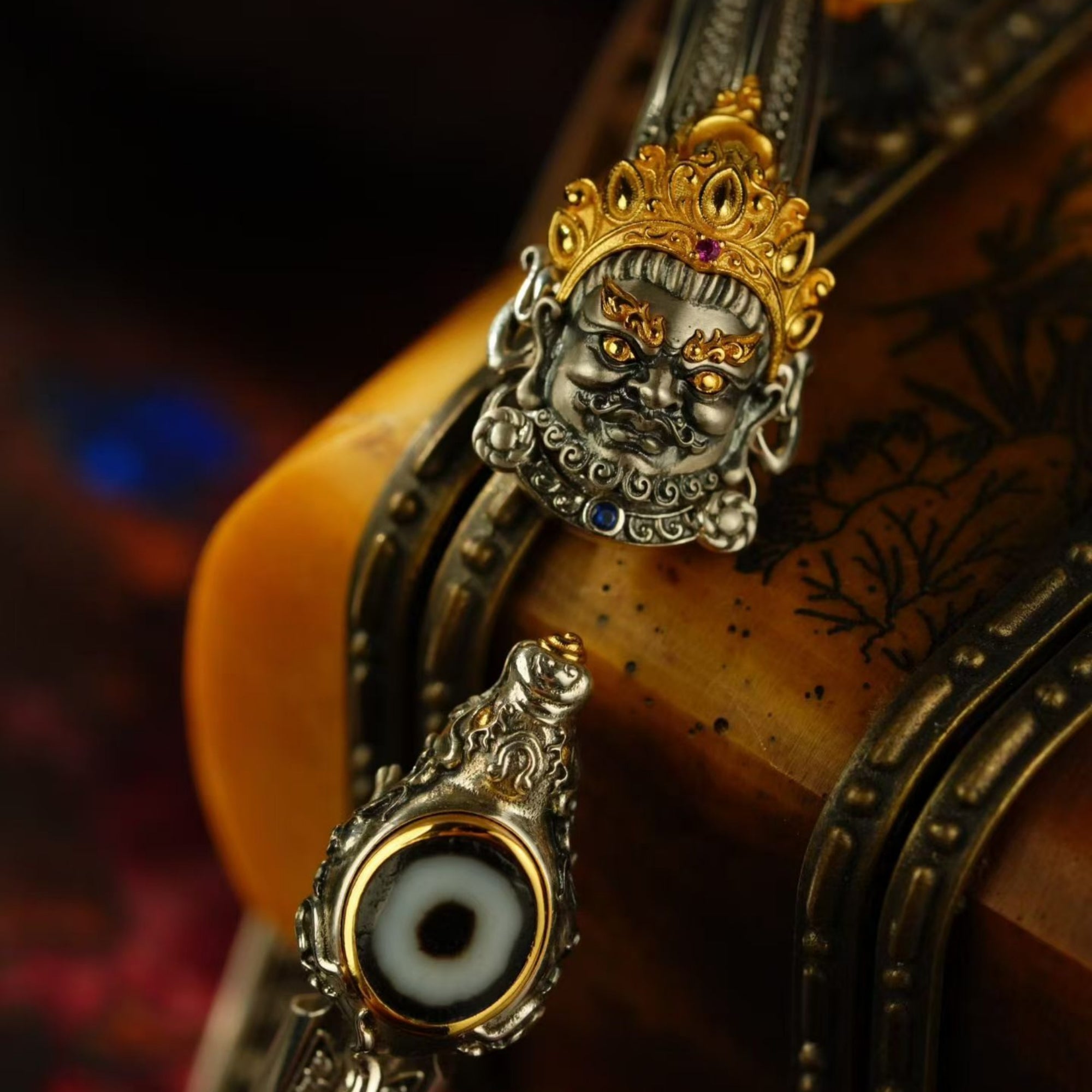 Decorative key with intricate design and evil eye symbol on a dark background