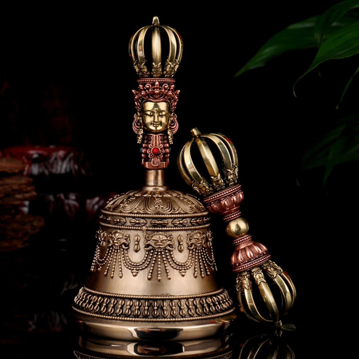 Decorative bell with intricate design and a crown-like top on a dark background