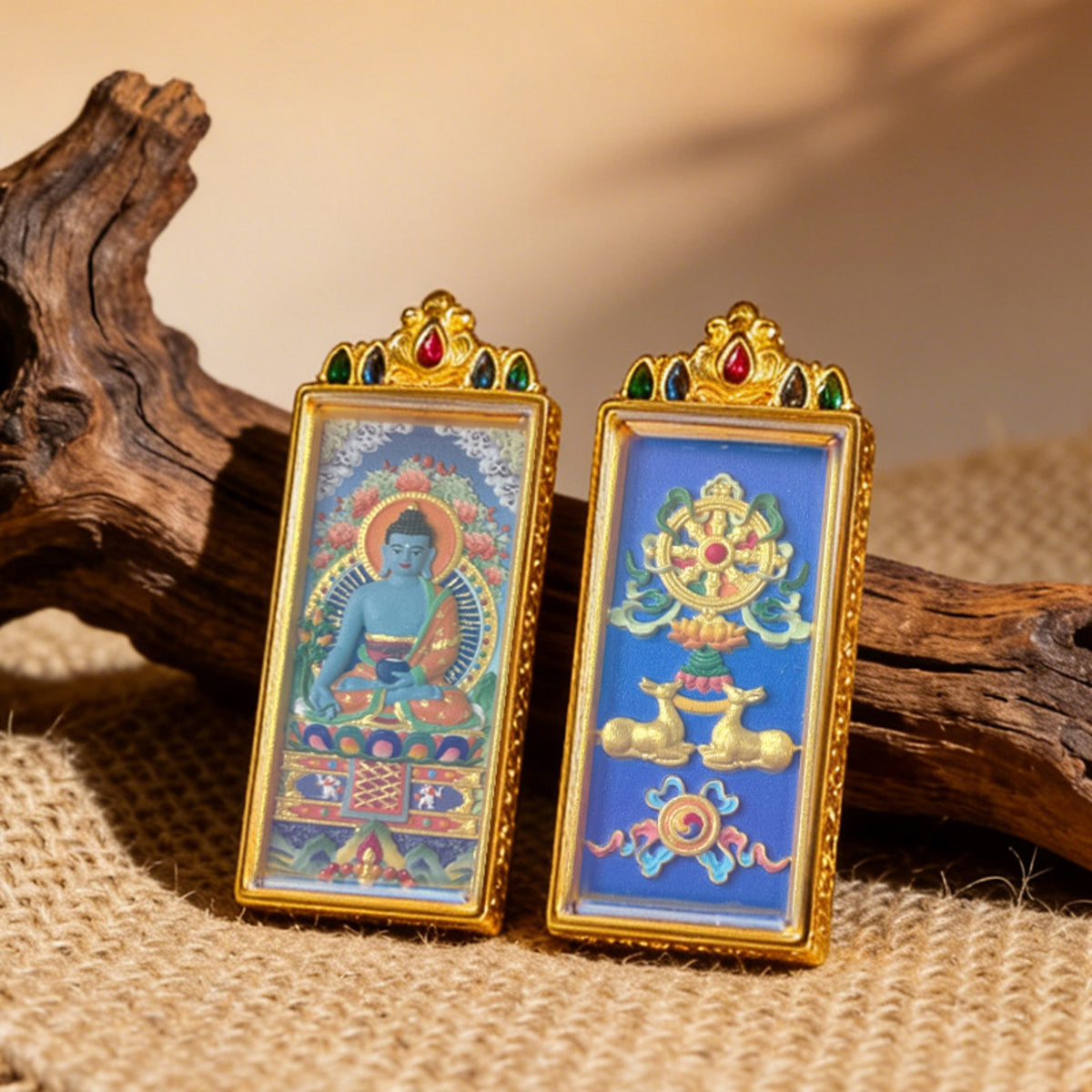 Two ornate framed artworks on a textured surface with wooden elements.