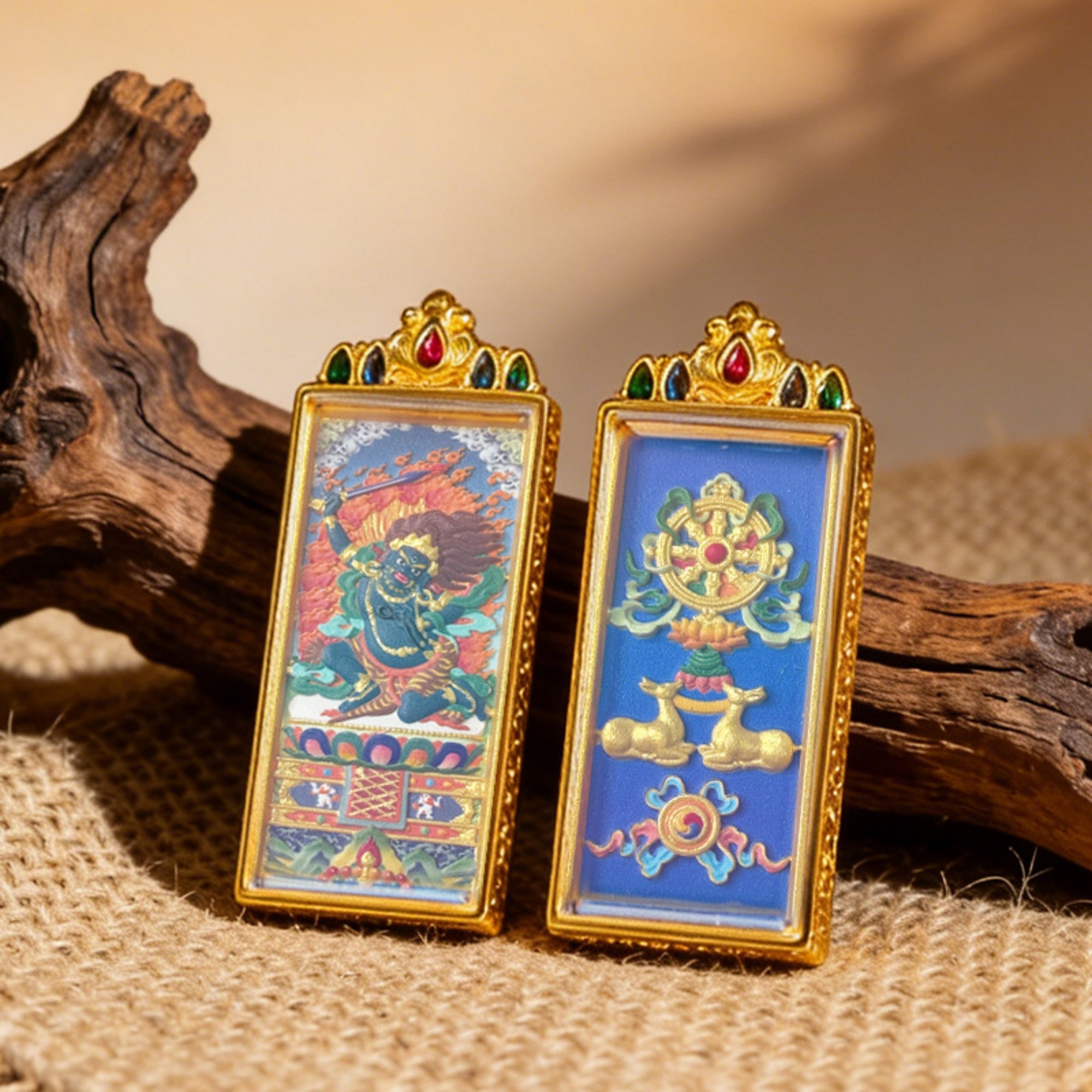 Two ornate framed artworks on a textured surface with wooden elements.