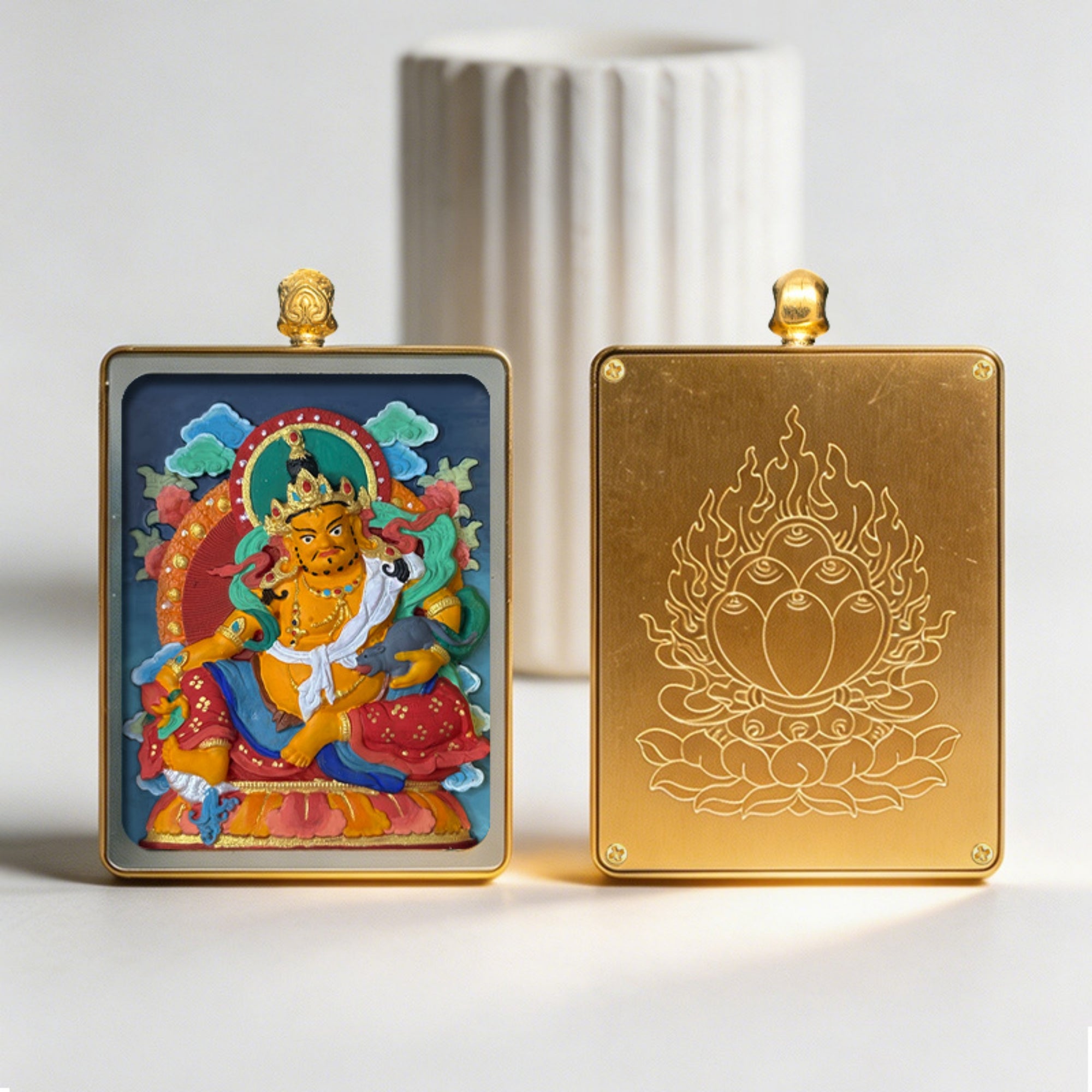 Two decorative items, one with a colorful figure and the other with a gold design, on a light background.