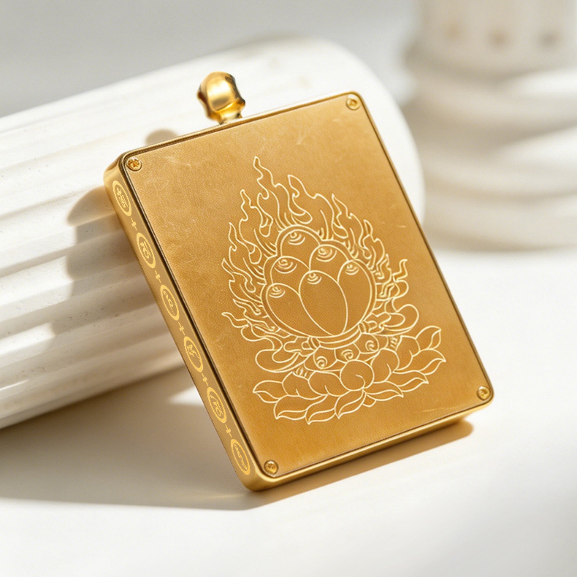 Gold pendant with intricate design on a light background