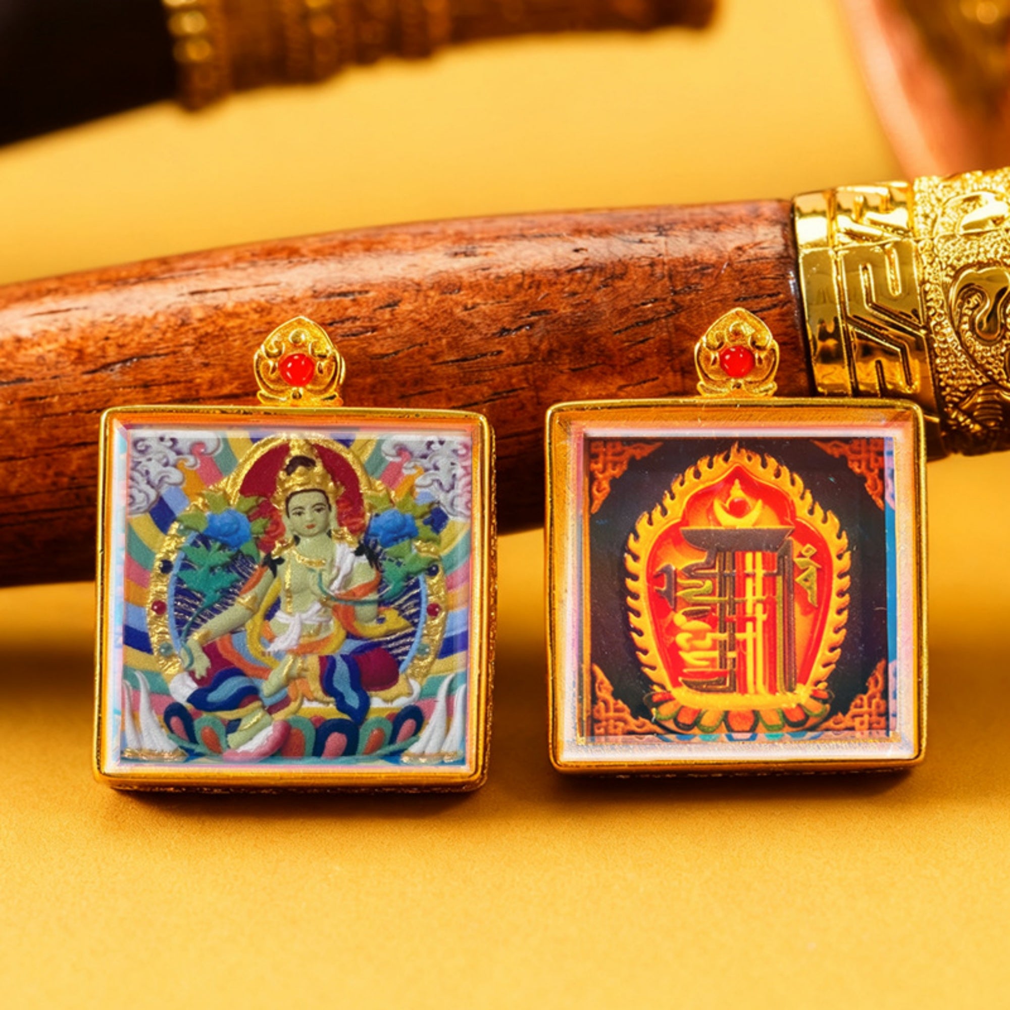 Two decorative pendants with intricate designs on a yellow background