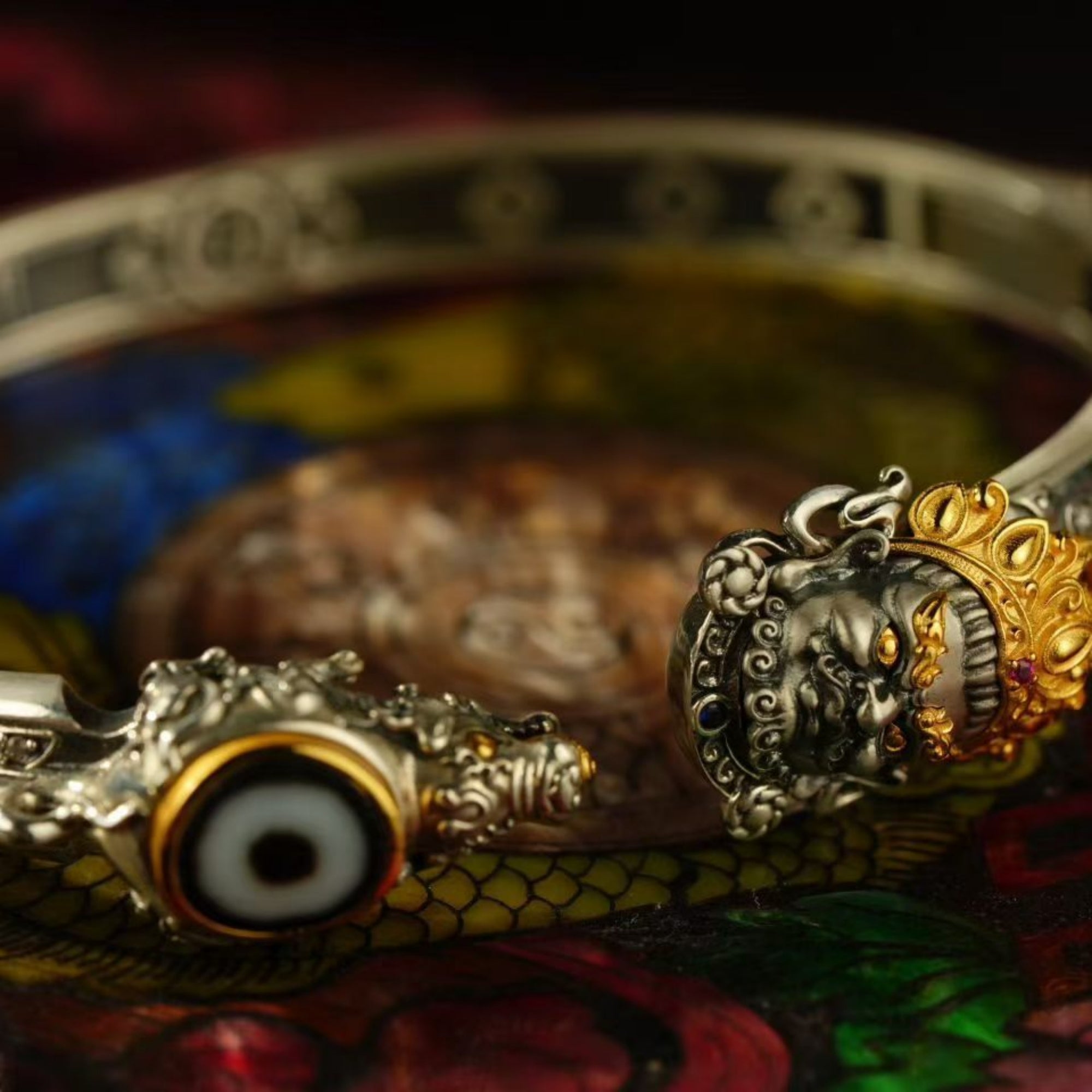 Decorative spoon with ornate handle and eye design on a colorful background
